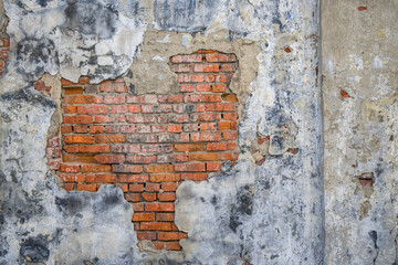 Grunge old red brick and plaster wall texture