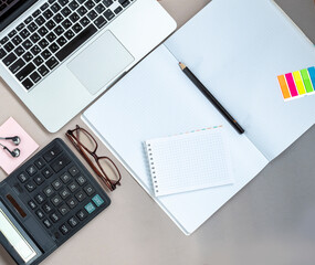 Flat lay of modern workplace for worker with laptop, headphones and coffee on yellow background