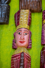 Handmade colorful rajasthani puppets hanging on blue colour wall for décor. Selective focus on...