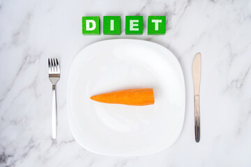 The concept of a vegetable diet. An empty white plate with a carrot on a white marble background