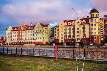 Fototapeta na wymiar Colored houses on the central embankment at sunset in Kaliningrad.