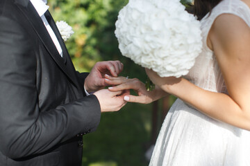 The groom wears a ring to the bride