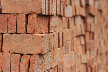 Stacked of orange bricks for building constuction