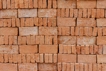Fototapeta premium Stacked of orange bricks for building constuction