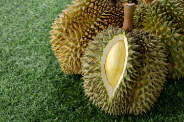 Peeled yellow Mon Thong durian on heap of durian fruits . Regarded by many people in southeast asia...