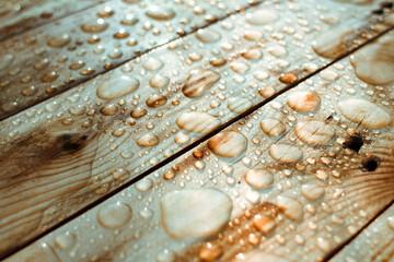 background of lacquered wood texture with shiny drops from the rain, wet wooden planks