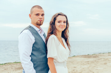 Husband and wife are photographed by the sea