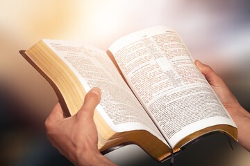 A human holding and read book with window  light, crisis solution pray to God, Christian