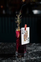 Alcoholic cocktail garnished with playing card. Bar menu concept.
