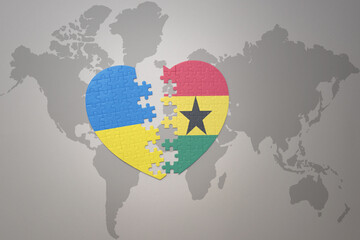 puzzle heart with the national flag of ukraine and ghana on a world map background. Concept.