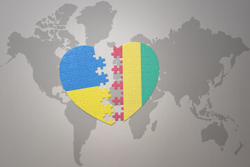 puzzle heart with the national flag of ukraine and guinea on a world map background. Concept.