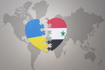 Fototapeta premium puzzle heart with the national flag of ukraine and syria on a world map background. Concept.