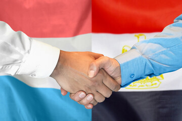 Handshake on Luxembourg and Egypt flag background. Support concept