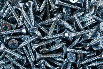 Background of white screws. Macro photography.