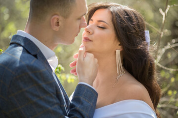 portrait of a man in a suit and a woman in a white dress close-up, the concept of a kiss.