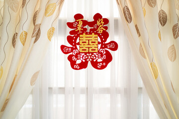 Chinese wedding “double happiness” text caligraphy on paper cut stick on the curtain. Chinese wedding decoration.