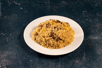 Traditional spicy indian Beef Biryani in a plate on marble background top view of pakistani pulao