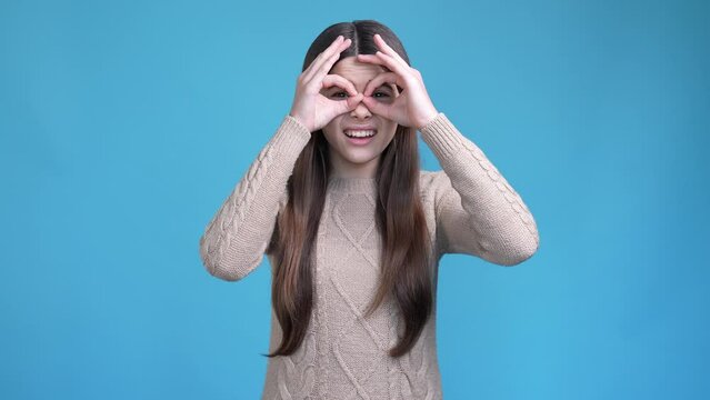 Teen kid not look far eye sight need spectacles isolated blue color background 
