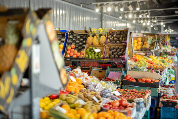 Fototapeta na wymiar Variety of fresh fruits on the market counters indoors