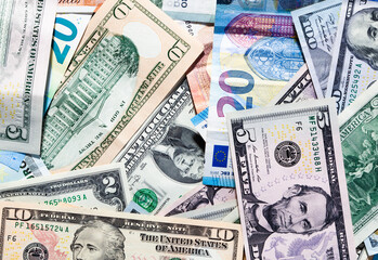 Fototapeta na wymiar close-up of US paper dollars and euro banknotes of various denominations