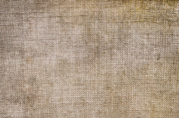 Background, texture of beige fabric, woven burlap close-up.