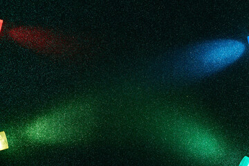 On a dark green background in fine grain, crossed oncoming wide and narrow beams of blue red and green gradient light