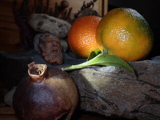 Still life with pomegranate and clementines - 505751031