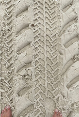 Detail of tire tracks or tires in the sand with toes showing the comparative size of the texture...