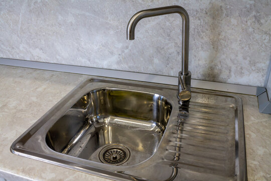 Mortise rectangular stainless steel kitchen sink with faucet. High quality photo