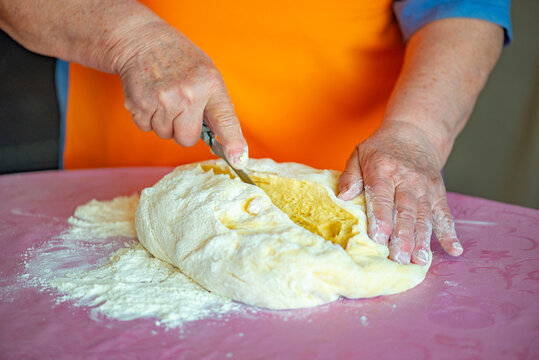 One Grandmother Kneads The Dough For Easter Cakes. High Quality Photo