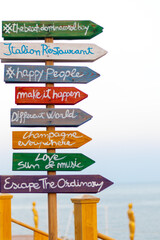 Funny multicolored wooden signpost on the beach in Egypt.