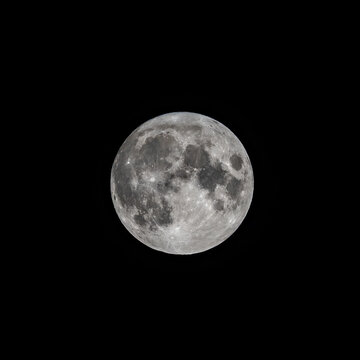 Detailed image of the full moon isolated on black.