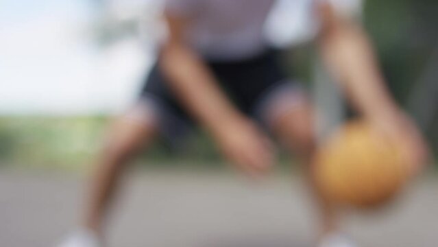 Blurred background of person dribbling a basketball with skill, in slow motion - great for foreground text