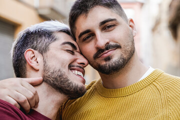 Gay male couple kissing outdoor in the city - LGBT love concept