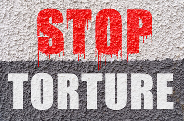 On the white-gray surface of the wall is the inscription - Stop torture