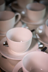 Fototapeta na wymiar white ceramic mugs stand on top of each other