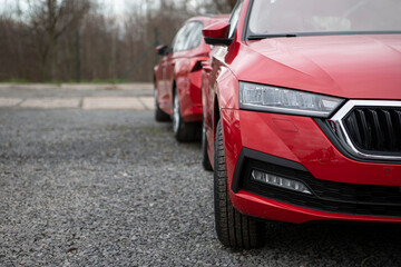 Half front end of newly made red passenger car. Left side empty and suitable for text. European...