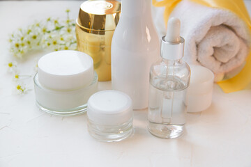 Fototapeta na wymiar Cosmetics in white, transparent and golden bottles. Skin care, spa, wellness, cosmetology.