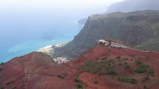 Aerial view of stunning viewpoint Mirador de Abrante with glass observation balcony above Agulo village in La Gomera island. Restaurant on red clay