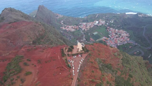 Aerial view of stunning viewpoint Mirador de Abrante with glass observation balcony above Agulo village in La Gomera island. Restaurant on red clay