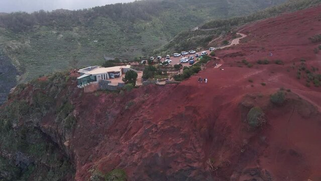 Aerial view of stunning viewpoint Mirador de Abrante with glass observation balcony above Agulo village in La Gomera island. Restaurant on red clay