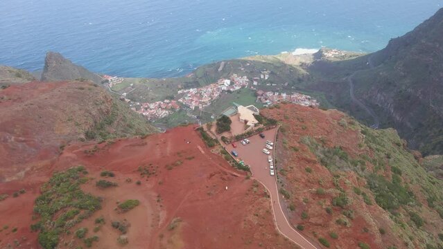 Aerial view of stunning viewpoint Mirador de Abrante with glass observation balcony above Agulo village in La Gomera island. Restaurant on red clay