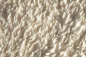 Close-up abstract background of white fluffy sheet.