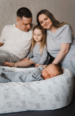 Portrait of loving family with newborn son and infant daughter. Happy caucasian family of four people. Selective focus. Film grain