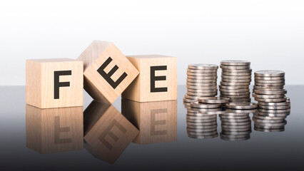 fee - text is made up of letters on wooden cubes lying on a mirror surface