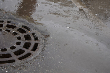 water from the rain drains into a drainage well. drainage system in the city
