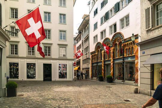 Switzerland, Zug, Swiss flags on buildings in old town