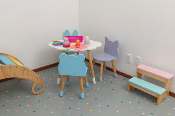 Children's area in pediatric office, with a table and chairs for children to draw