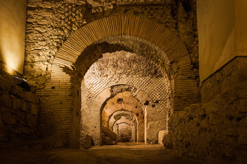 Naples underground (Napoli Sotteranea) at the archaeological excavations of San Lorenzo Maggiore, Naples, Italy. View of the ruins of the Macellum, the ancient Roman market. - obrazy, fototapety, plakaty