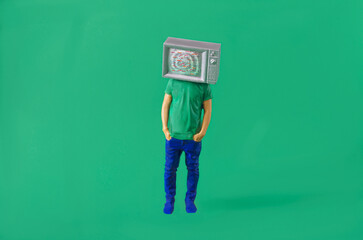 A man with a television instead of a head. Creative concept for manipulation and propaganda by mass...